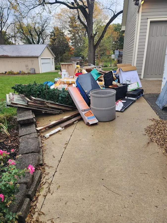 Dumpster being loaded with debris for 12 Yard Dumpster Rental in Live Oak